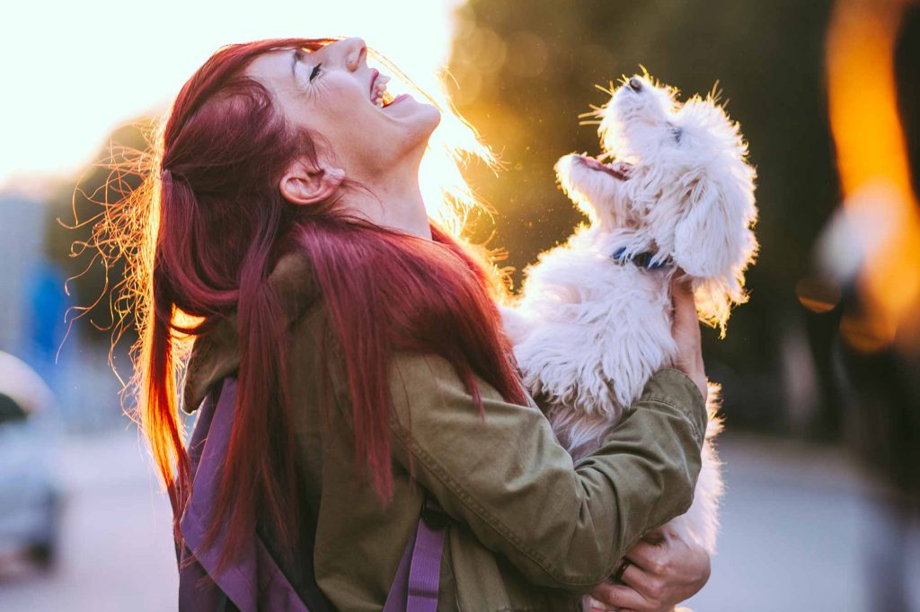 A woman and dog laughing